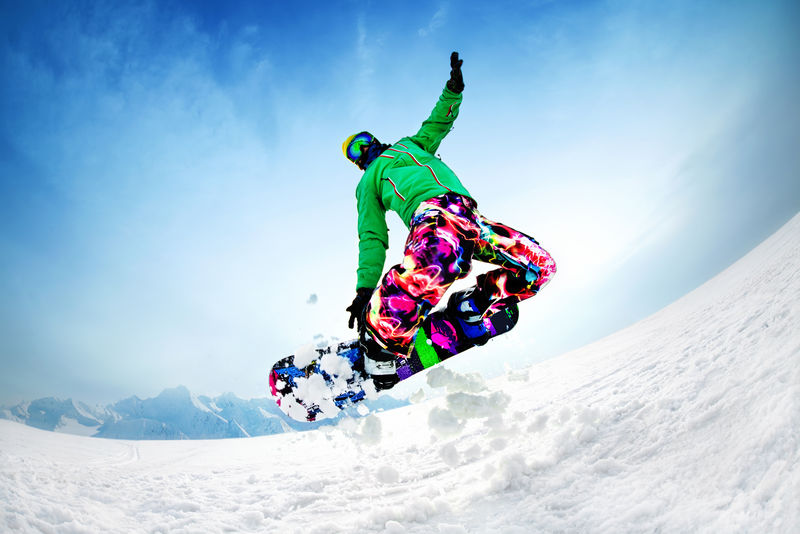 snowboarder jumping from the mountain along the road extreme
