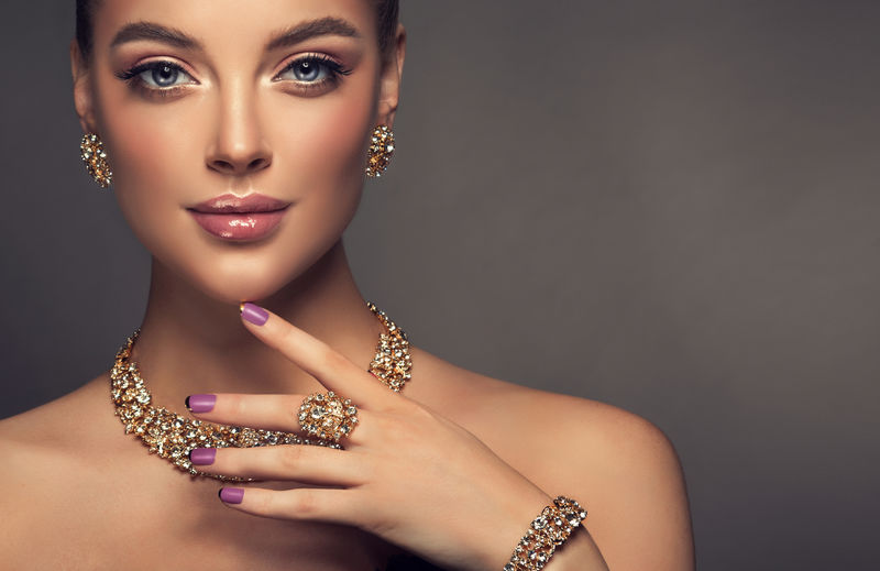 戴着珠宝的漂亮女孩-一套女人用的珠宝项链耳环和手镯-美容和配饰