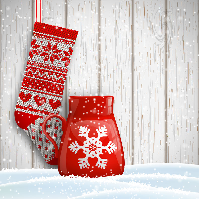 针织圣诞长袜和红茶杯饰以抽象的白色雪花插图