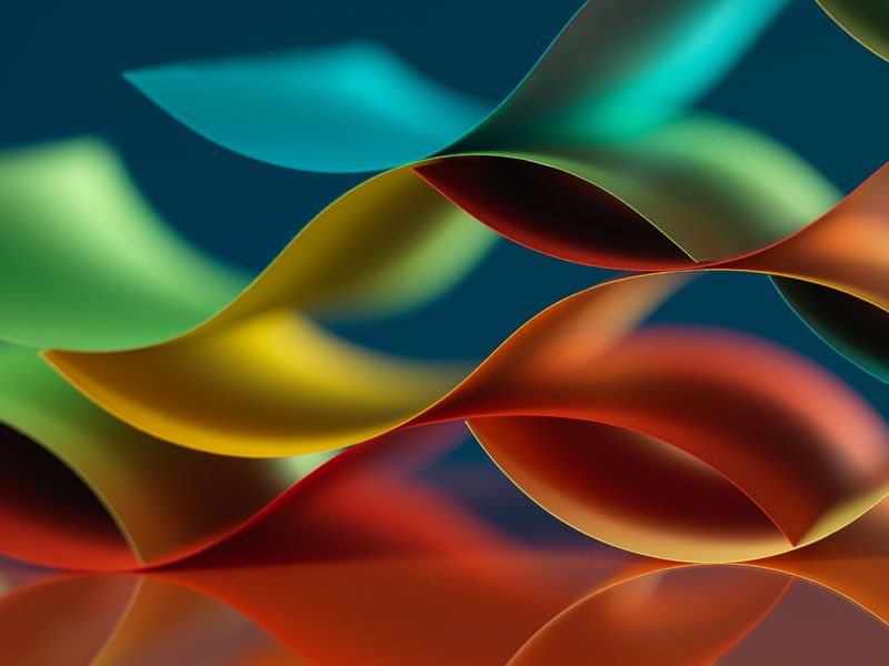 彩色折纸图案的背景宏观图像-由弯曲的纸片制成-带有反射镜