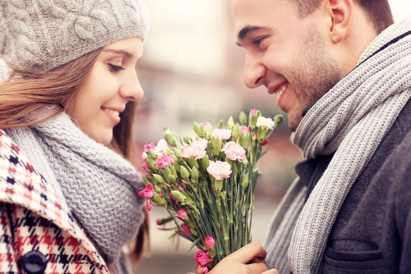 一个男人在冬天给他的情人献花的照片
