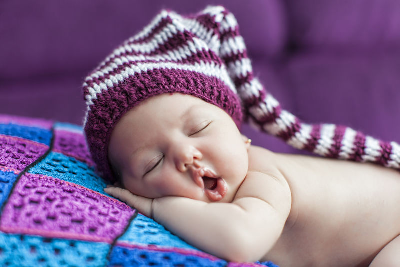 可爱的新生婴儿戴着帽子睡觉
