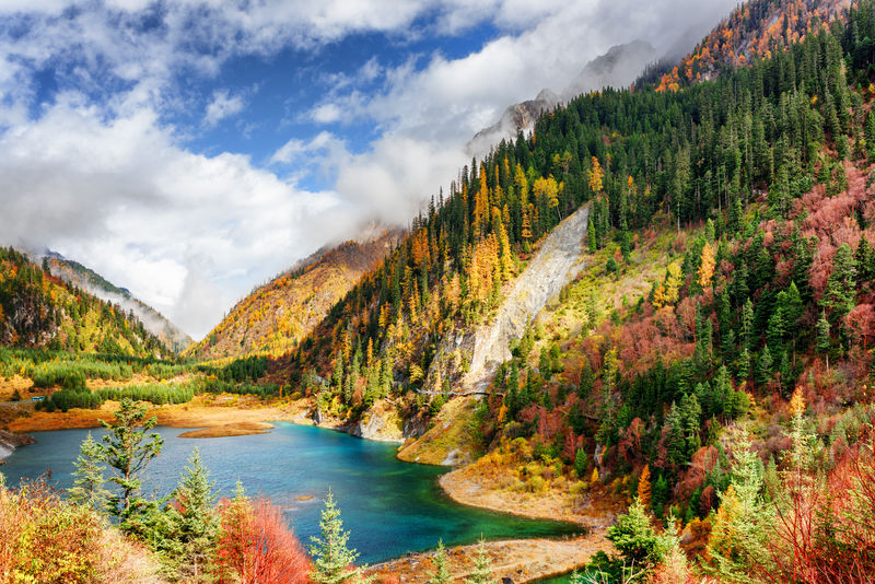 色彩斑斓的秋林山间的季节性湖泊