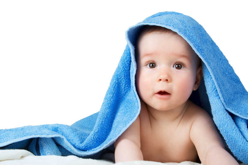 可爱的八个月大的婴儿裹在毛巾里