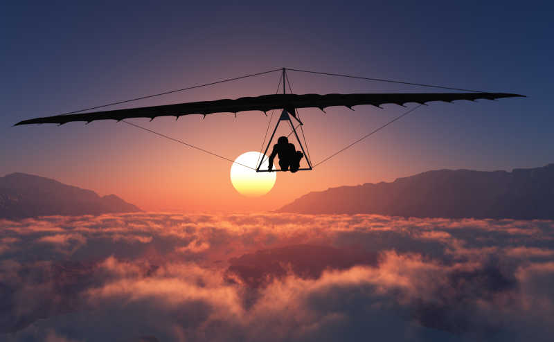 日落时使用滑翔伞的人