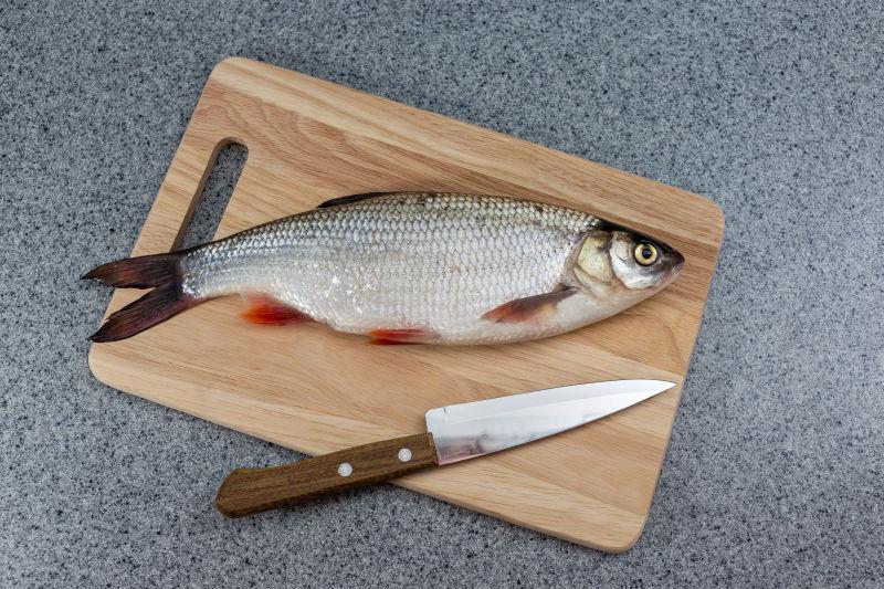 色的鱼在切割板和刀上