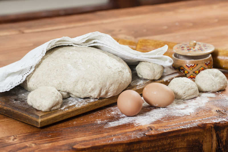 砧板上制作面包使用的面团和鸡蛋