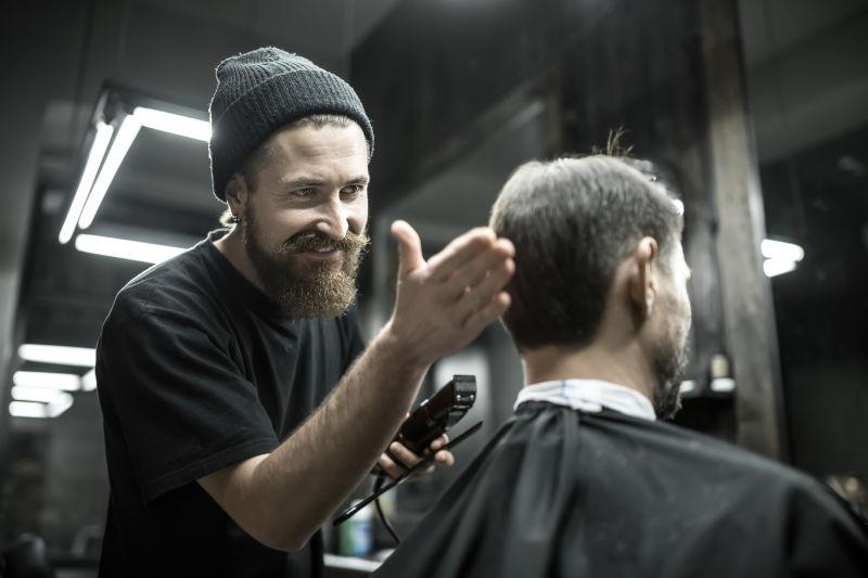 男性理发师正在给男性顾客理发